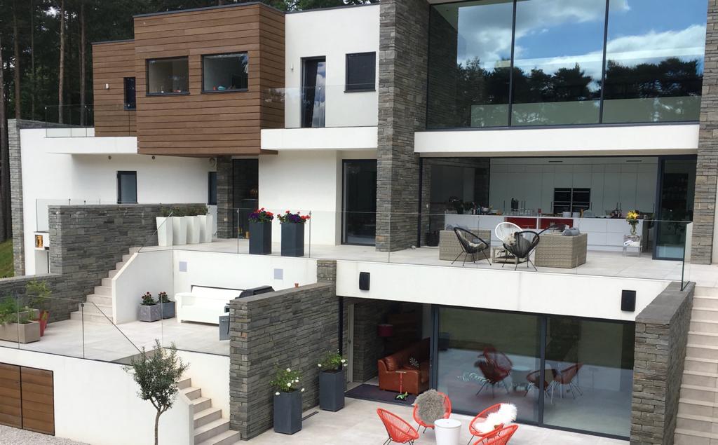 Living spaces open to the terrace through full-height glass