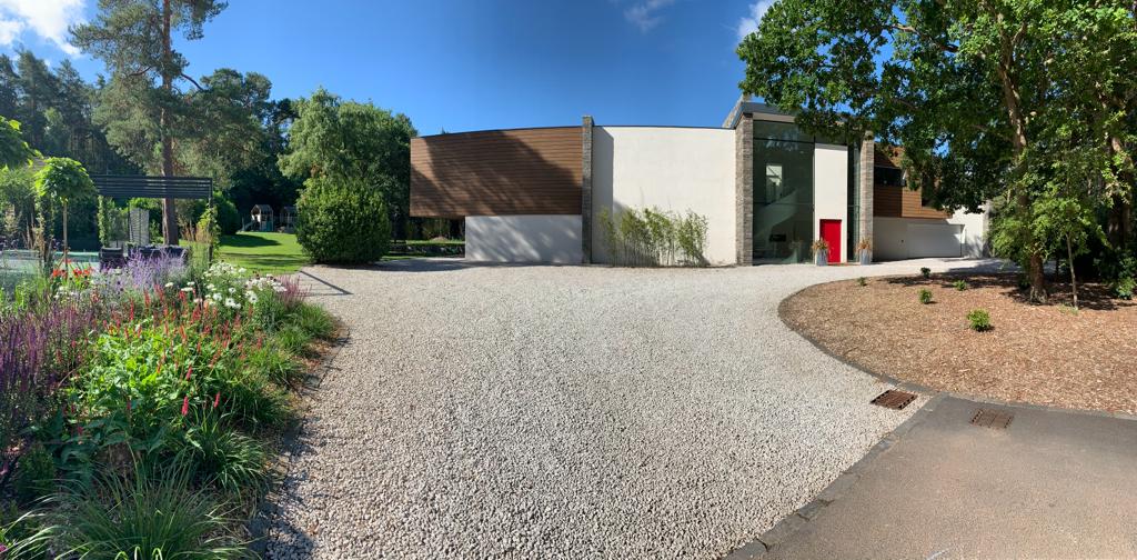 The contemporary house set within its wooded Surrey grounds